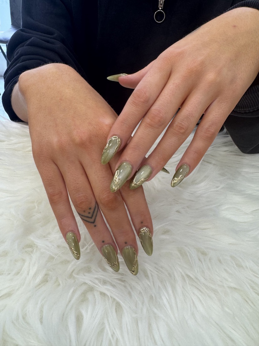 Olive-green chrome stiletto nails with molten 3D gold detailing