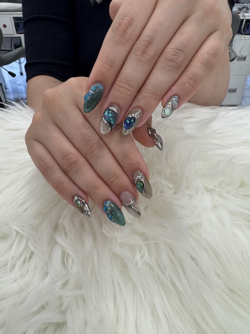 Silver chrome nails with 3D opal gemstone detail, done at American Nail Designs in Dalston